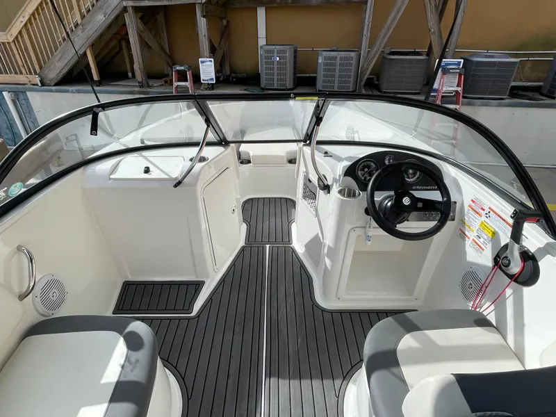 Slide: The Image of 2021 Bayliner Element E21 boat interior with steering wheel and seating. - 19