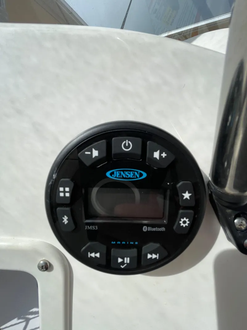 Slide: The Image of Jensen audio system on 2021 Bayliner Element E21 boat dashboard with Bluetooth controls. - 23