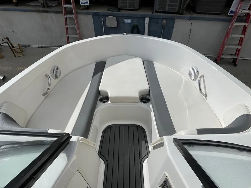 Slide: The Image of 2021 Bayliner Element E21 boat interior with gray seating and cup holders. - 26