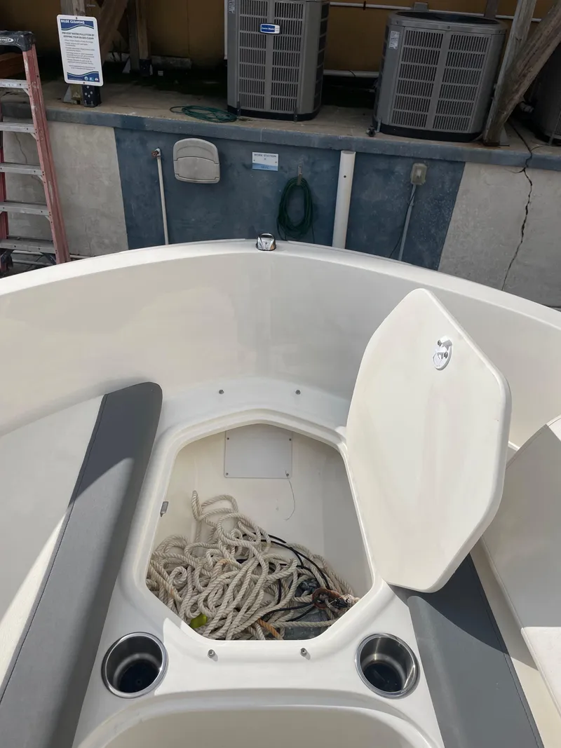 Slide: The Image of 2021 Bayliner Element E21 boat with open storage compartment and ropes. - 28