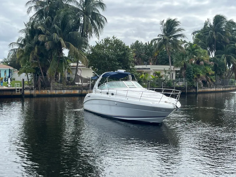 Slide: The Image of 2003 Sea Ray 360 Sundancer yacht cruising on a calm, tropical waterway. - 1