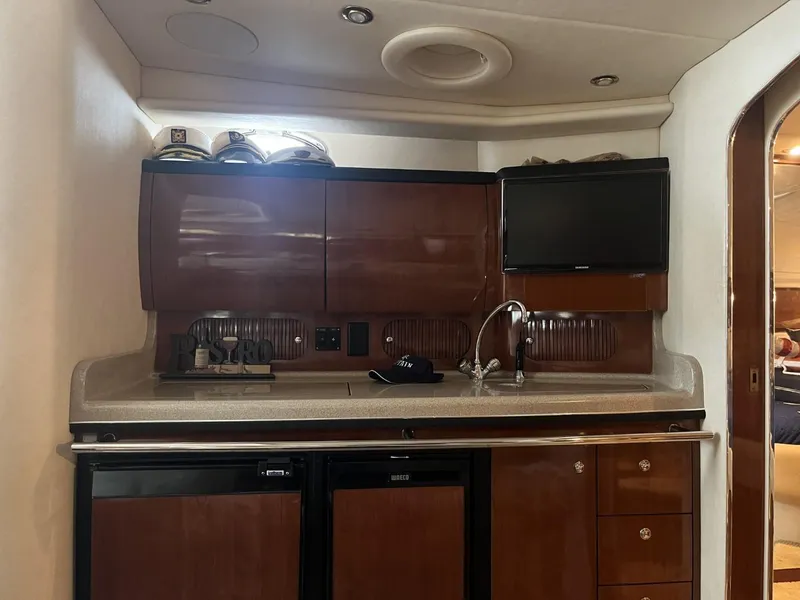 Slide: The Image of 2003 Sea Ray 360 Sundancer yacht interior with kitchenette and TV. - 11
