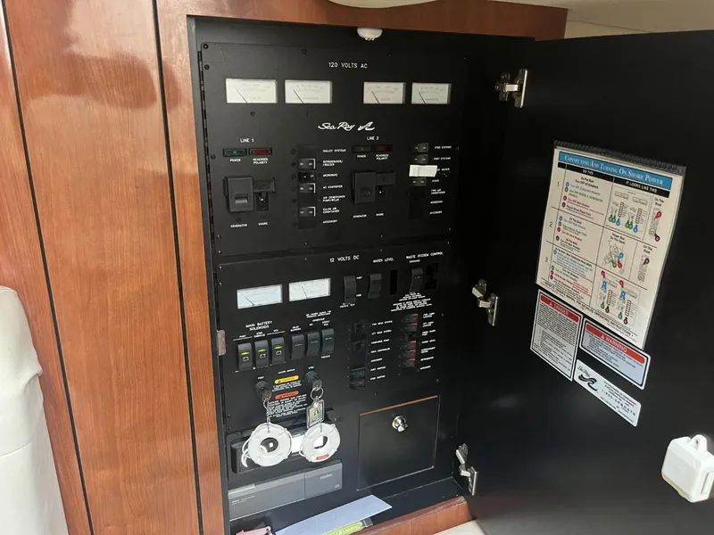 Slide: The Image of Electrical panel inside a 2003 Sea Ray 360 Sundancer boat, featuring various switches and labels. - 12