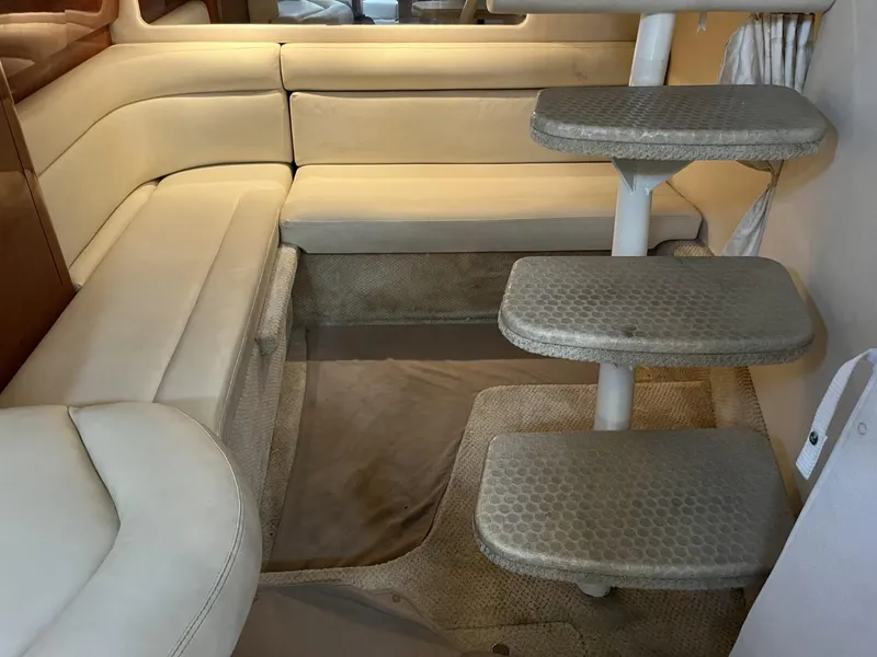 Slide: The Image of Interior of 2003 Sea Ray 360 Sundancer with beige seating and carpeted steps. - 24
