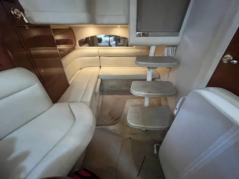 Slide: The Image of Interior of 2003 Sea Ray 360 Sundancer yacht with beige seating and steps. - 25