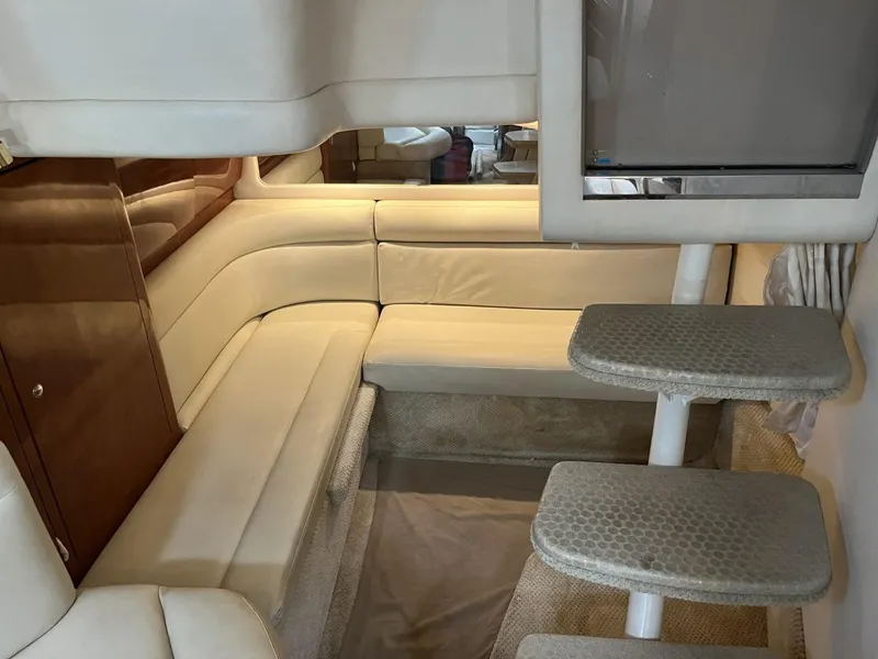 Slide: The Image of Interior of 2003 Sea Ray 360 Sundancer with beige seating and carpeted steps. - 27