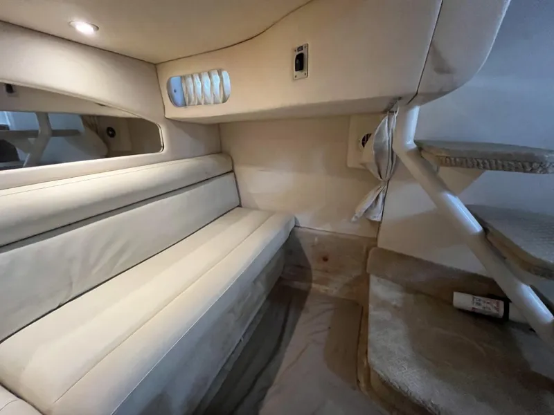 Slide: The Image of Interior cabin of 2003 Sea Ray 360 Sundancer with beige seating and stairs. - 28