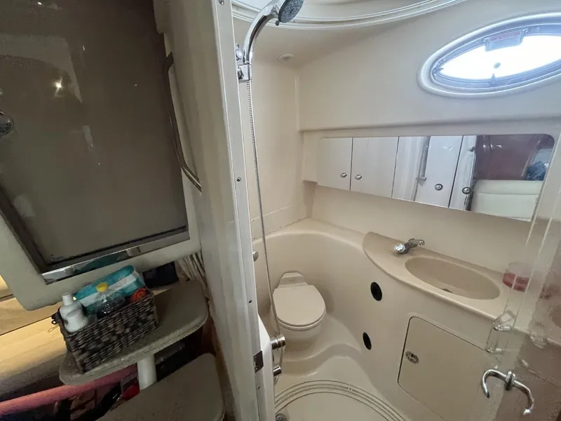 Slide: The Image of Bathroom interior of 2003 Sea Ray 360 Sundancer yacht, featuring shower, sink, and storage. - 30