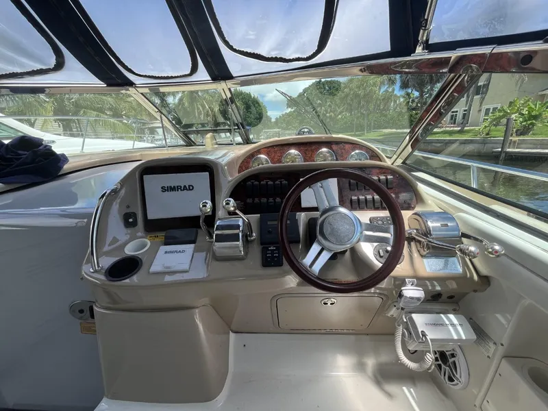 Slide: The Image of Helm of 2003 Sea Ray 360 Sundancer with steering wheel and navigation equipment. - 31