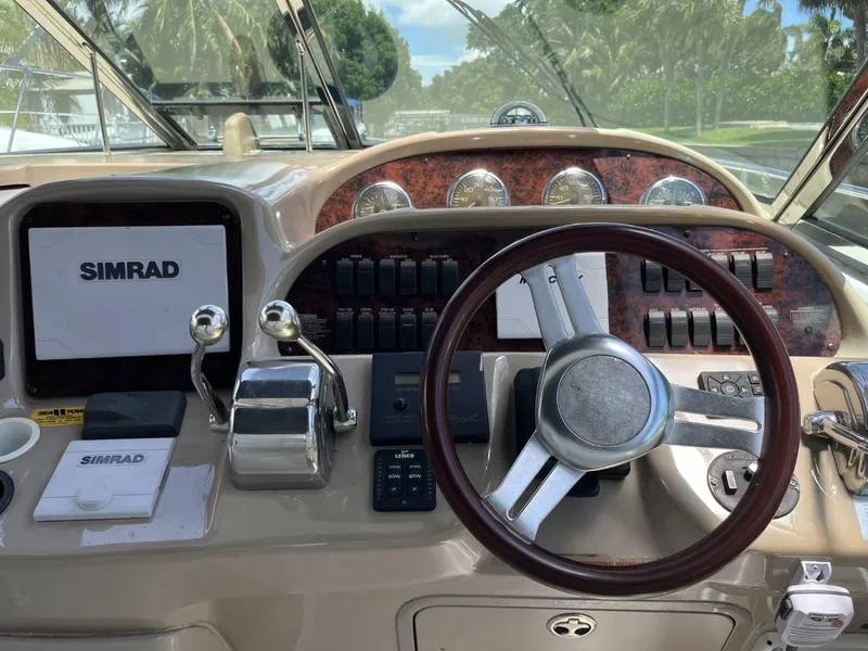 Slide: The Image of 2003 Sea Ray 360 Sundancer helm with Simrad navigation system and classic wood accents. - 32