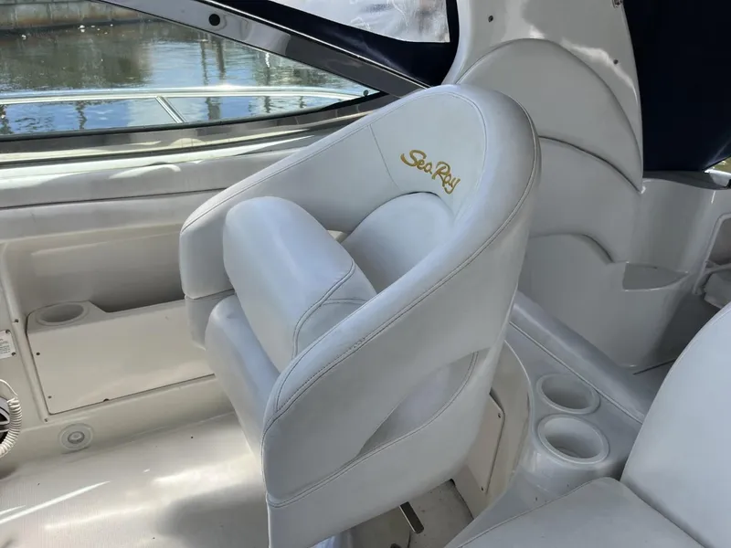 Slide: The Image of 2003 Sea Ray 360 Sundancer interior with white seating and cup holders. - 33