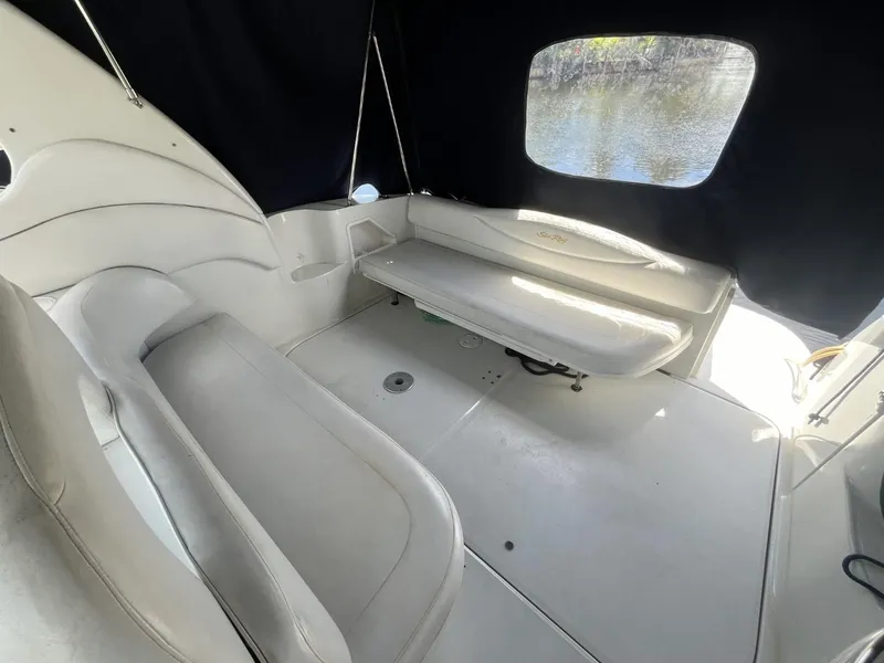 Slide: The Image of 2003 Sea Ray 360 Sundancer interior with white seating and black canopy. - 36