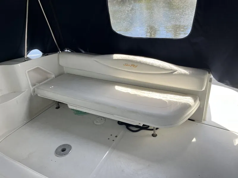 Slide: The Image of 2003 Sea Ray 360 Sundancer interior with white seating and dark canopy. - 37