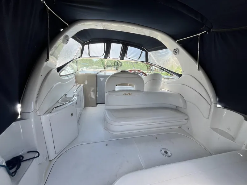 Slide: The Image of 2003 Sea Ray 360 Sundancer interior with white seating and covered cockpit. - 39