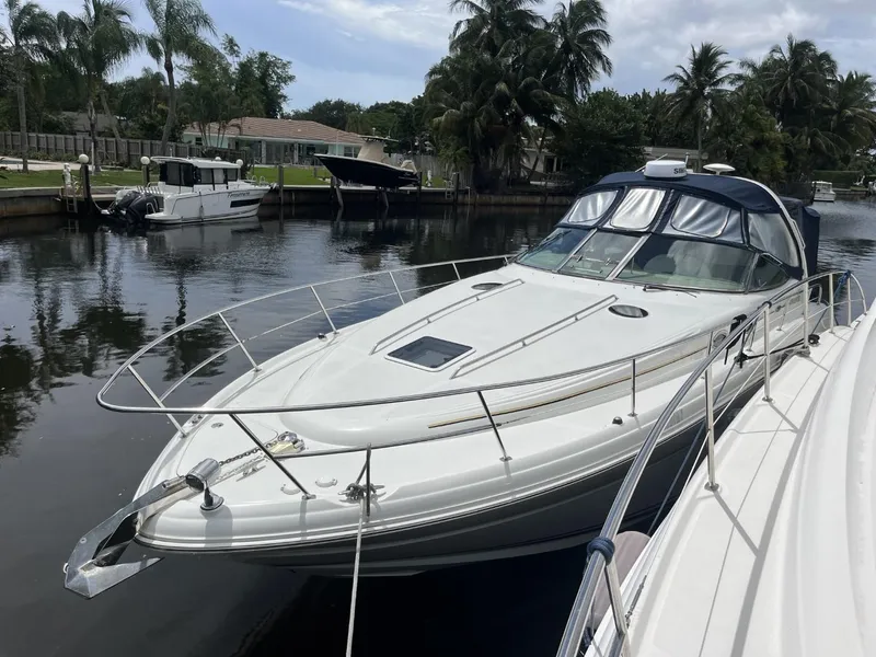 Slide: The Image of 2003 Sea Ray 360 Sundancer yacht docked in a serene canal setting. - 40