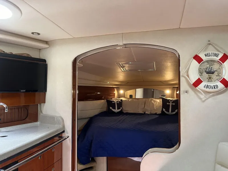 Slide: The Image of Interior of 2003 Sea Ray 360 Sundancer with cozy cabin and nautical decor. - 45