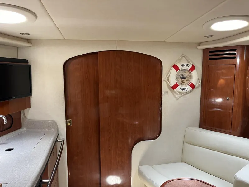 Slide: The Image of Interior of 2003 Sea Ray 360 Sundancer yacht with wood finish and seating area. - 48