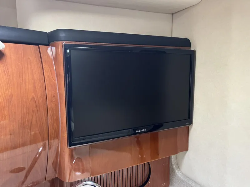 Slide: The Image of Samsung TV mounted in 2003 Sea Ray 360 Sundancer cabin with wooden paneling. - 6