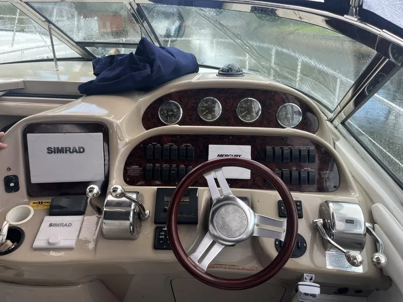 Slide: The Image of 2003 Sea Ray 360 Sundancer helm with Simrad navigation and classic wood steering wheel. - 9