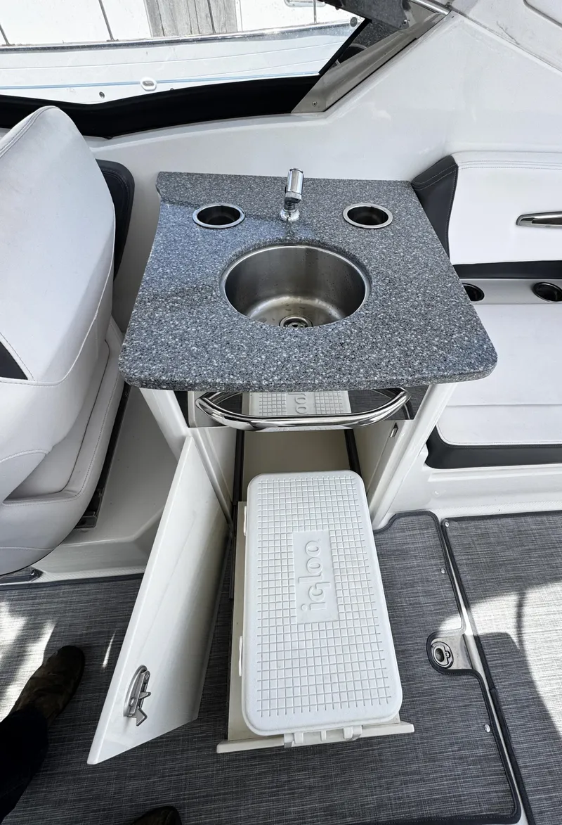 Slide: The Image of 2018 Chaparral 307 SSX boat interior with sink and storage compartment. - 6
