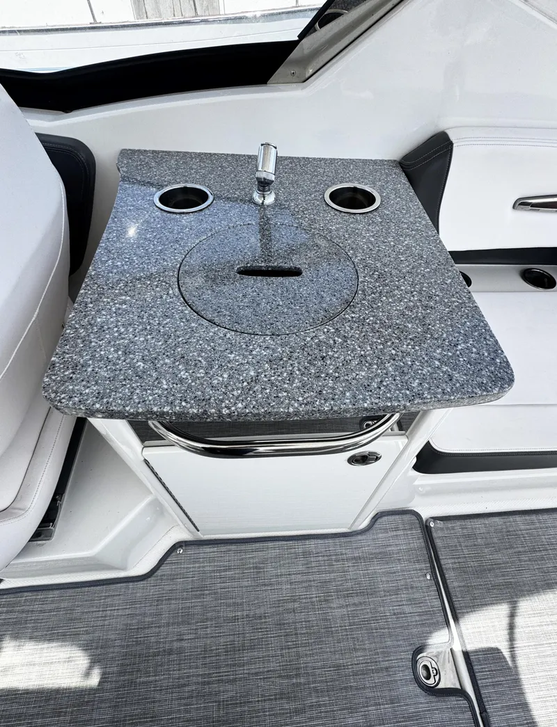 Slide: The Image of 2018 Chaparral 307 SSX boat interior with granite countertop and built-in sink. - 7