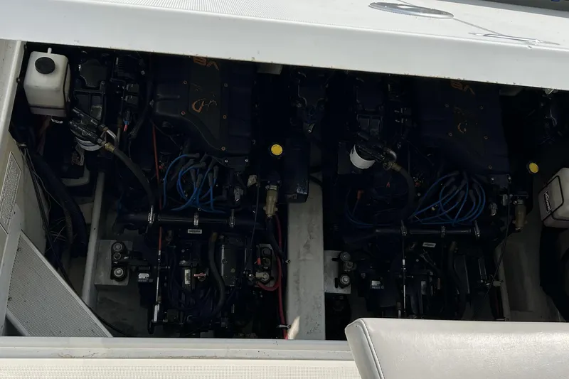 Slide: The Image of Engine compartment of a 1999 Formula 34 PC boat, showcasing dual engines and wiring. - 21