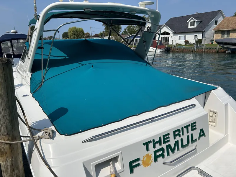 Slide: The Image of 1999 Formula 34 PC boat docked, featuring teal cover and "The Rite Formula" text. - 5