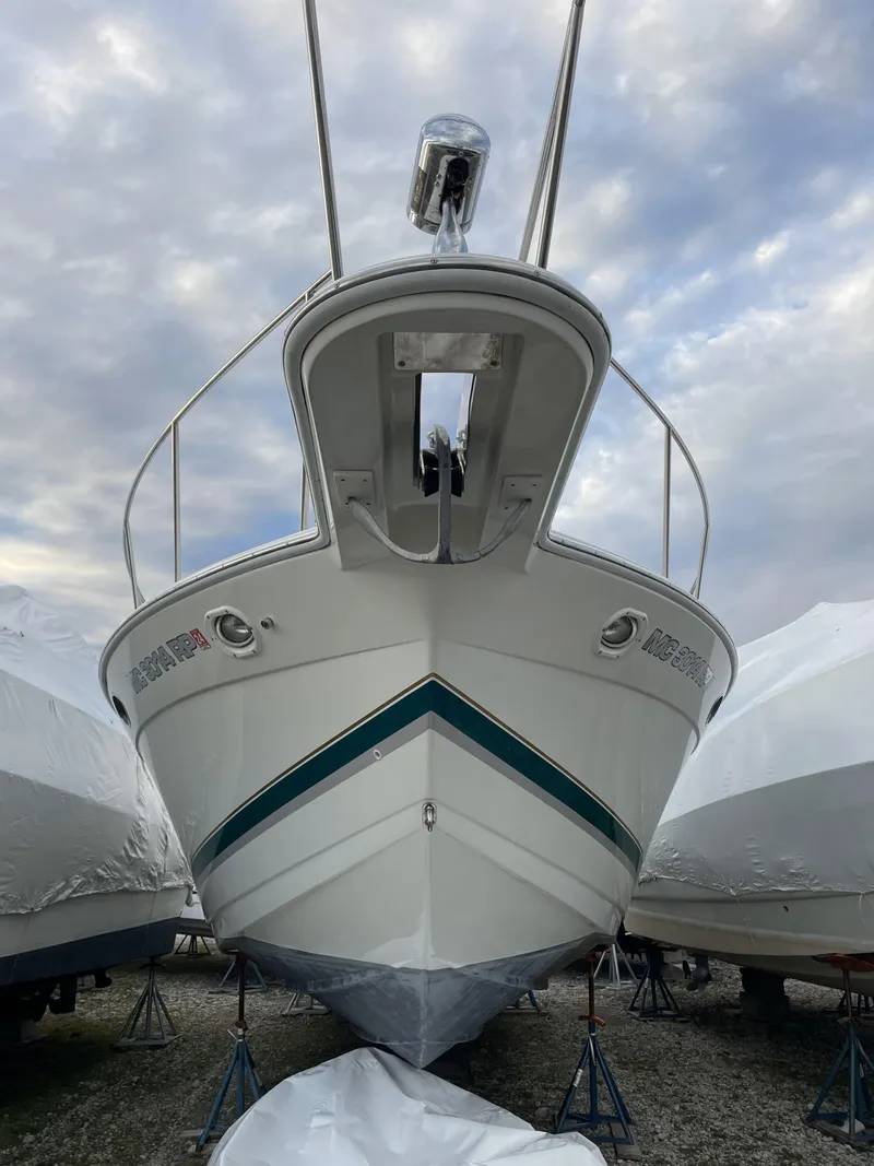 Slide: The Image of 1999 Formula 34 PC boat on stands, viewed from the front under a cloudy sky. - 7