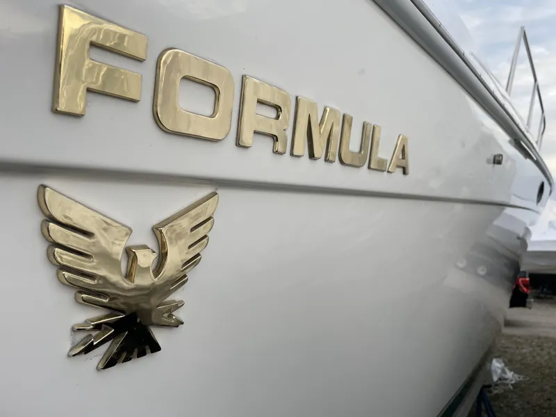 Slide: The Image of 1999 Formula 34 PC boat with gold emblem and logo on the side. - 9