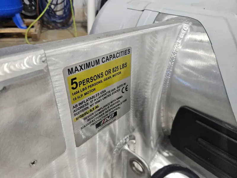 Slide: The Image of 2024 AB Inflatables Lammina 9.5 AL capacity label, maximum 5 persons or 825 lbs. - 12