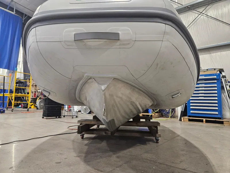 Slide: The Image of 2024 AB Inflatables Lammina 9.5 AL boat in a workshop setting. - 2