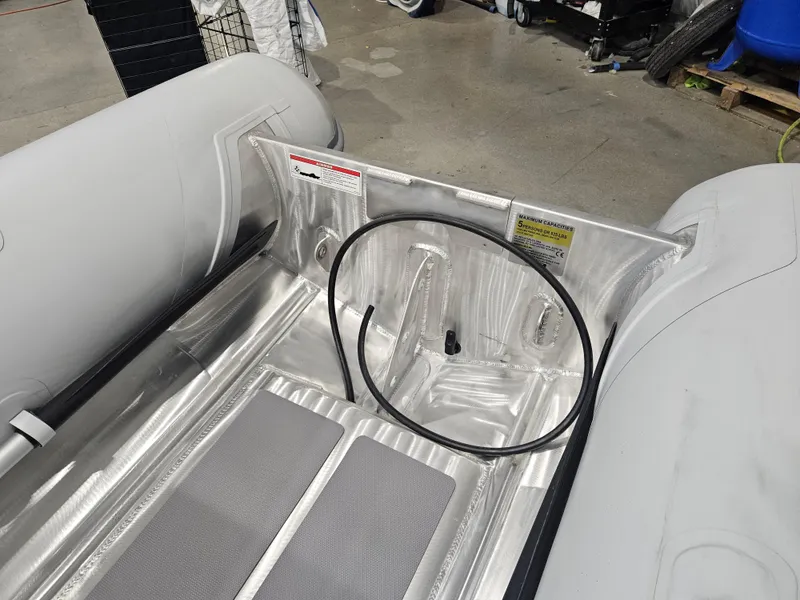 Slide: The Image of 2024 AB Inflatables Lammina 9.5 AL interior view, showcasing aluminum floor and inflatable sides. - 3