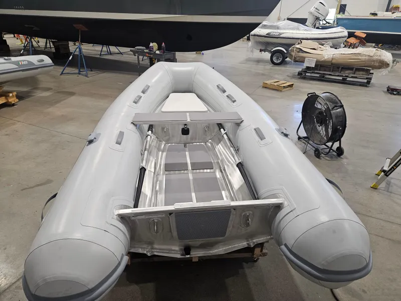 Slide: The Image of 2024 AB Inflatables Lammina 9.5 AL boat in a workshop setting. - 4