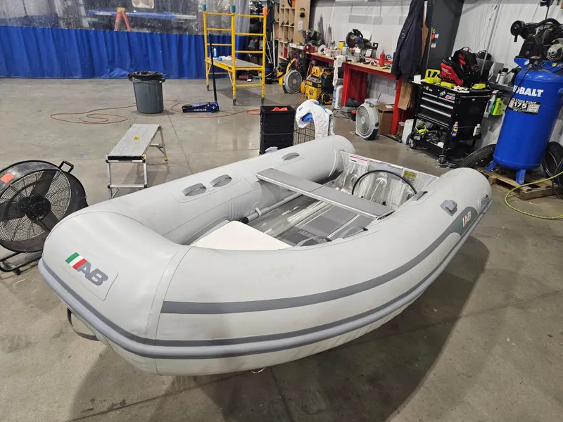 The Image of 2024 AB Inflatables Lammina 9.5 AL boat in a workshop setting. - 5