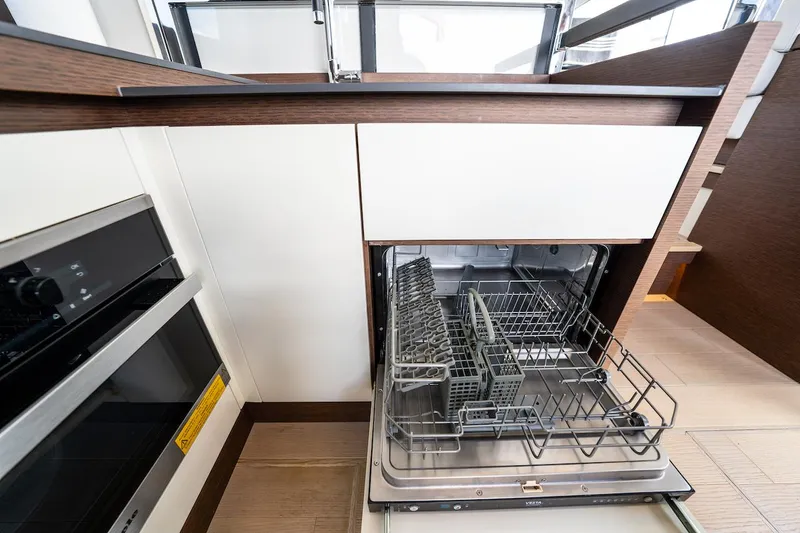 Slide: The Image of Open dishwasher in 2020 Prestige 520 Fly yacht kitchen interior. - 15