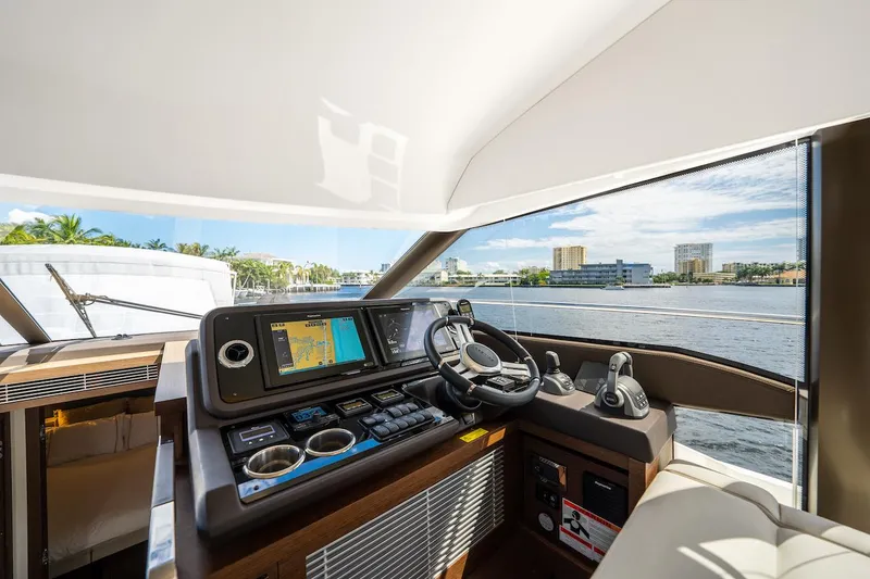 Slide: The Image of Helm of 2020 Prestige 520 Fly yacht with navigation system, overlooking waterfront. - 18
