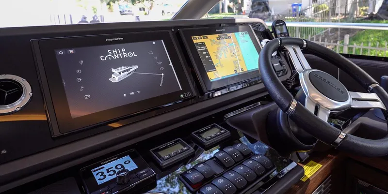 Slide: The Image of Prestige 520 Fly 2020 yacht helm with advanced navigation displays and controls. - 19