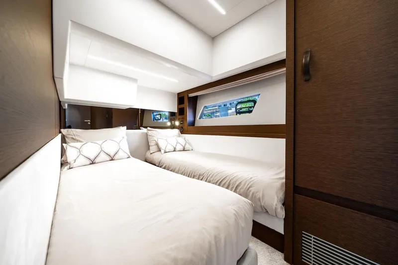 Slide: The Image of Luxurious twin cabin interior of 2020 Prestige 520 Fly yacht, featuring modern design and cozy bedding. - 27