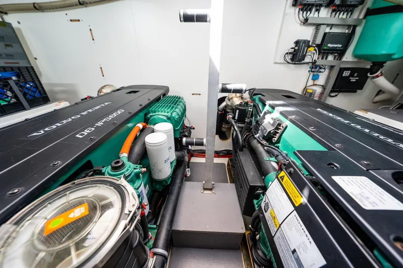 Slide: The Image of Engine room of a 2020 Prestige 520 Fly yacht, showcasing dual engines and mechanical components. - 31