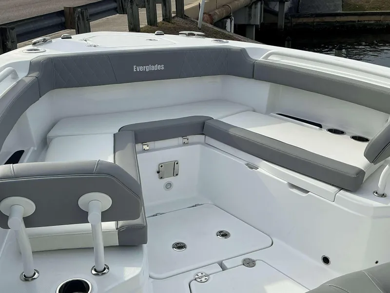 Slide: The Image of 2025 Everglades 285 CC boat interior with gray seating and cup holders. - 5