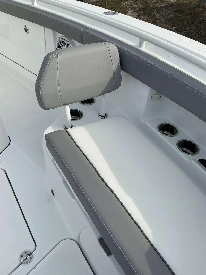 Slide: The Image of 2025 Everglades 285 CC boat interior with gray seating and cup holders. - 6