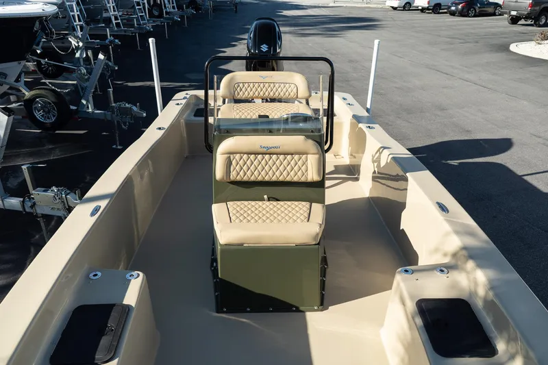 Slide: The Image of 2025 Savannah SS21 Duck boat with beige seating and center console, parked on pavement. - 13