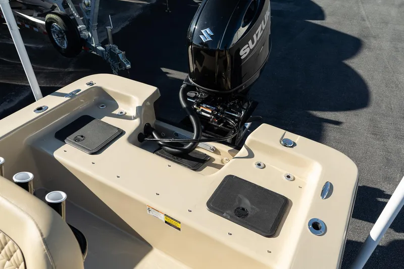 Slide: The Image of 2025 Savannah SS21 Duck boat with Suzuki outboard motor, beige interior, and cup holders. - 16