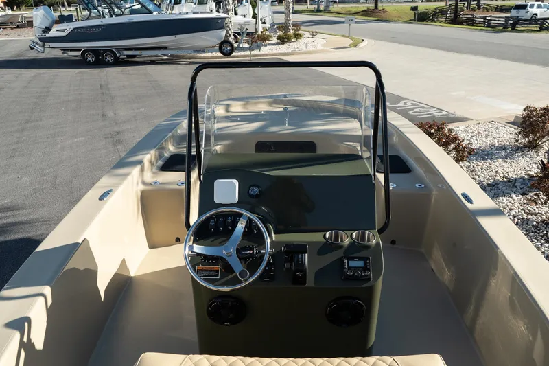 Slide: The Image of 2025 Savannah SS21 Duck boat interior with steering wheel and console, parked outdoors. - 19