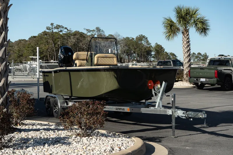 Slide: The Image of 2025 Savannah SS21 Duck boat on trailer, parked outdoors near palm tree. - 8