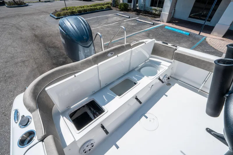 Slide: The Image of 2025 Sea Hunt Ultra 229 boat interior with open storage compartments and Yamaha outboard motor. - 13