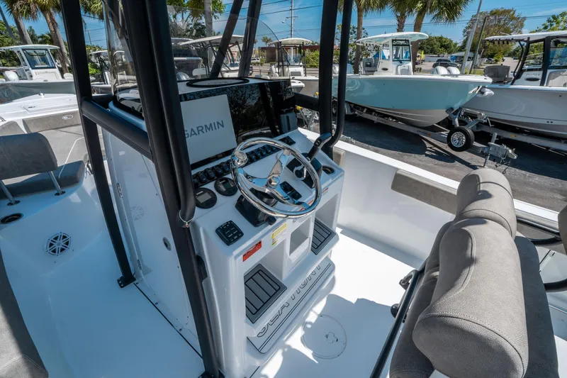 Slide: The Image of 2025 Sea Hunt Ultra 229 boat interior with Garmin navigation system and steering wheel. - 15