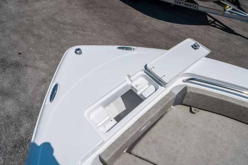 Slide: The Image of 2025 Sea Hunt Ultra 229 boat bow with storage compartment and seating. - 24