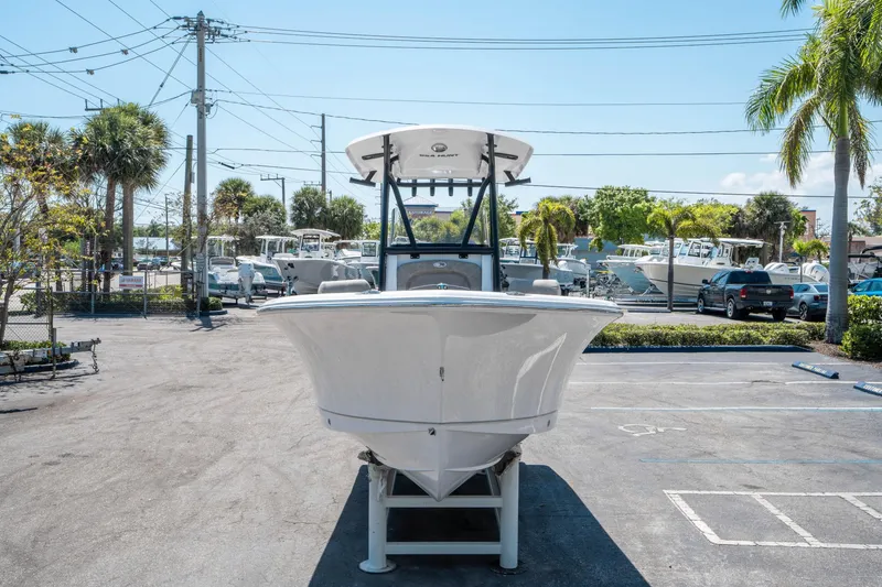 Slide: The Image of 2025 Sea Hunt Ultra 229 boat displayed in a sunny outdoor showroom. - 7