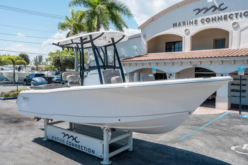 Slide: The Image of 2025 Sea Hunt Ultra 229 boat displayed at Marine Connection dealership. - 8
